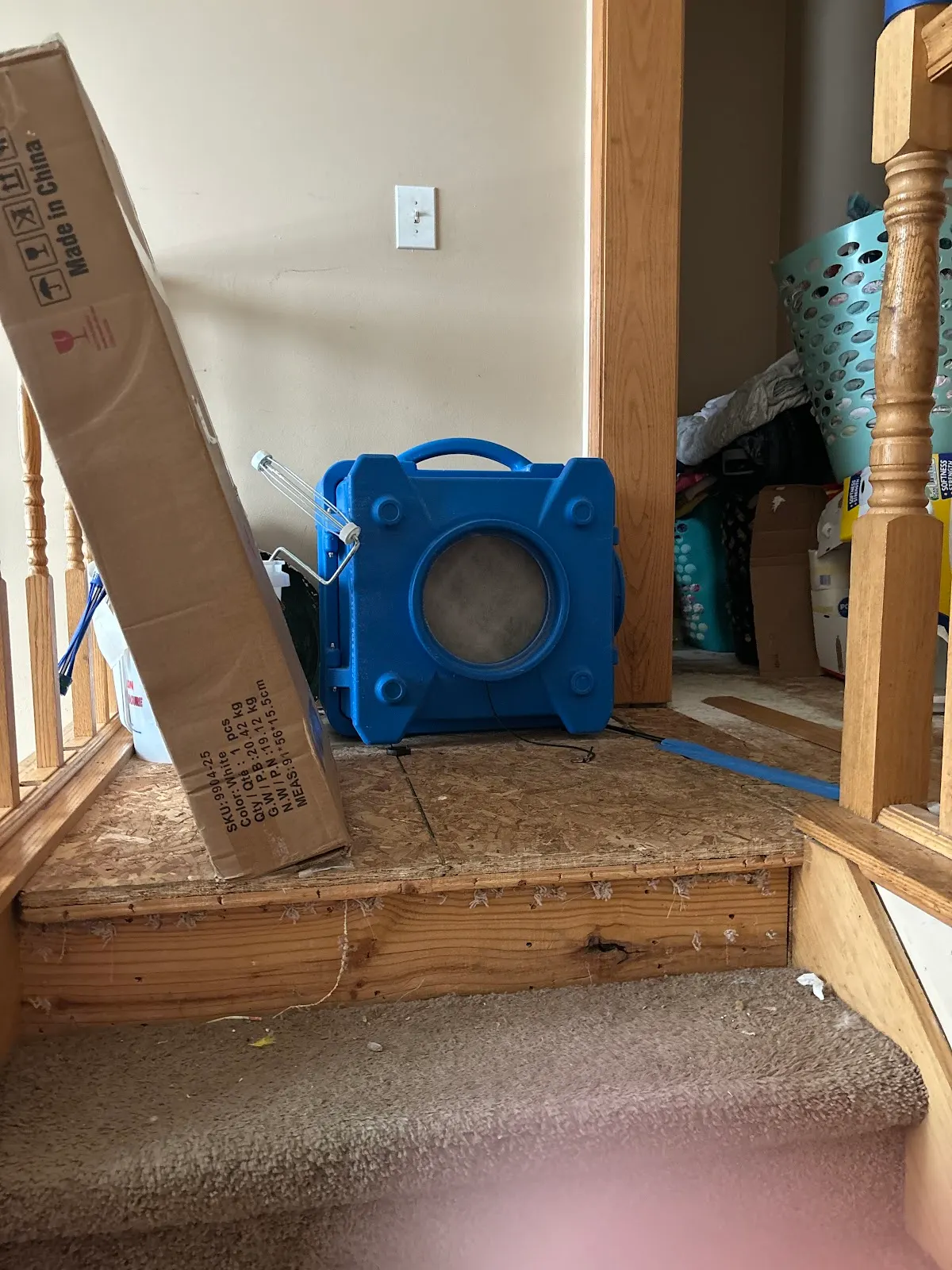 Air mover drying exposed framing during a flooded basement cleanup